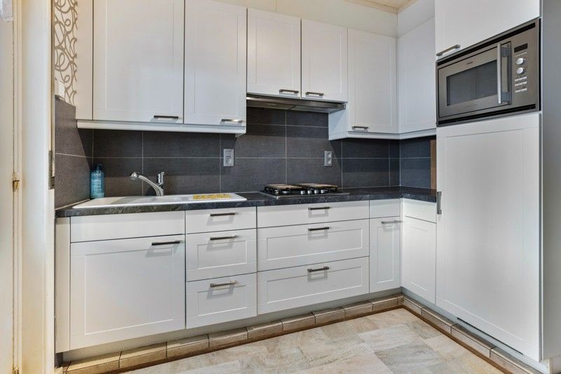 🏡 Veelzijdige woning met tuin, garages & potentieel in Vilvoorde foto {{pictureIndex}}
