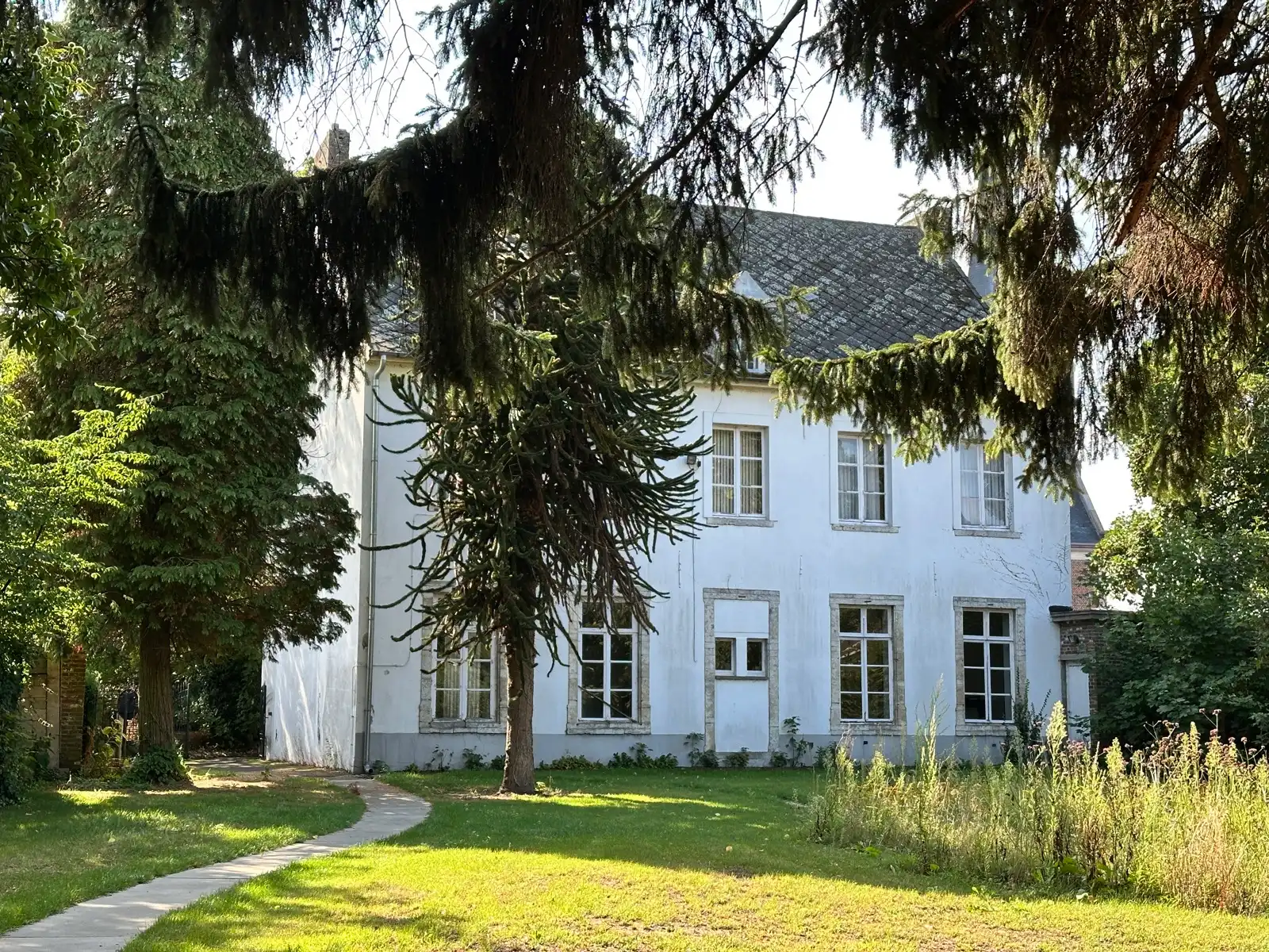 In de schaduw van de kerktoren bevindt zich deze mooie historische idyllische unieke pastorie.   foto 11