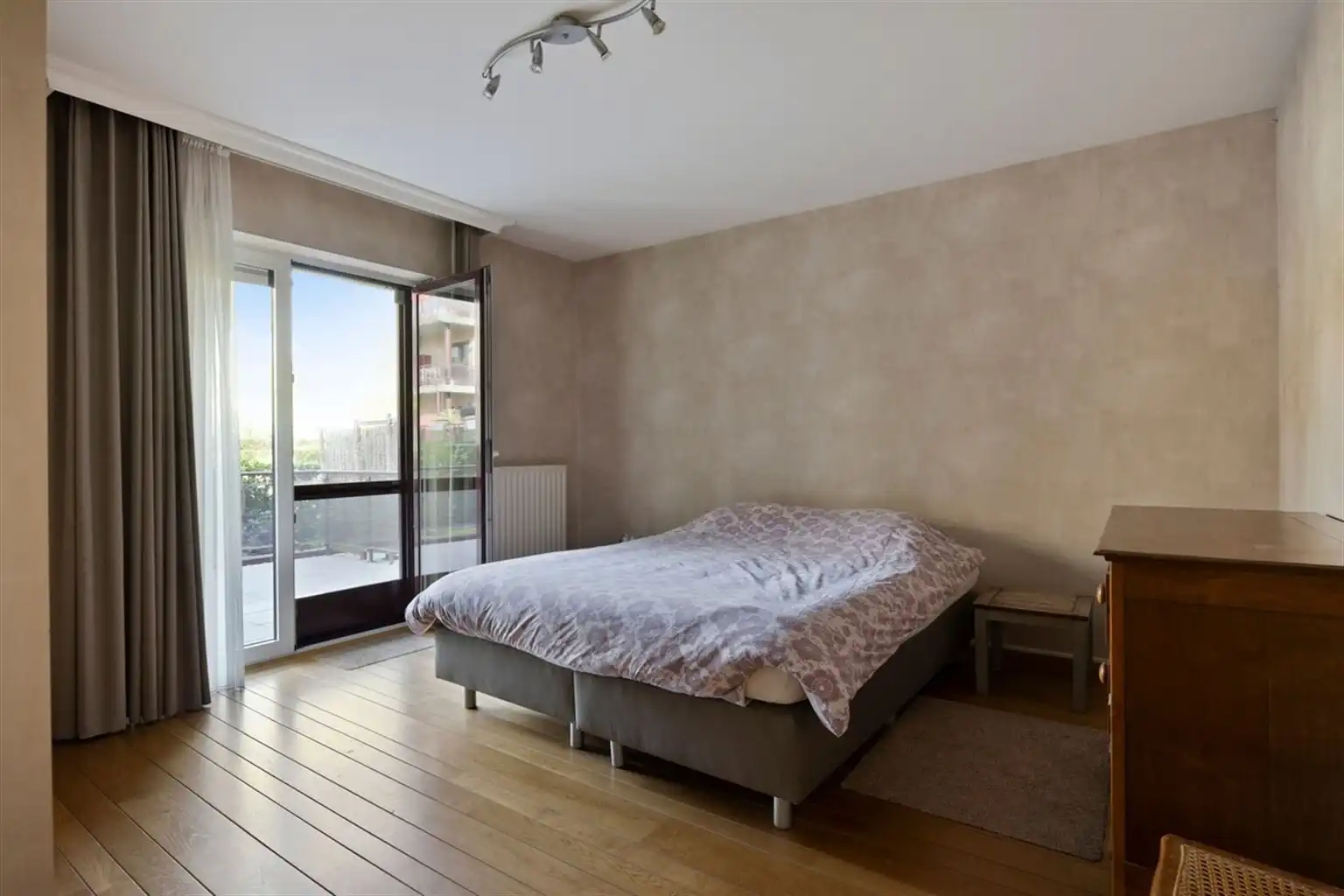 Uitzonderlijk ruim, gelijkvloers 2-slaapkamer appartement met terras en tuintje, zonnepanelen en inpandige garagebox gelegen vlakbij het centrum van Maaseik. foto 14