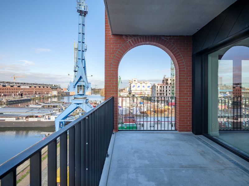 Ruim 2slpk-appartement met zuid-west georiënteerd terras aan de ‘Nieuwe Dokken’. Een appartement met een fenomenaal zicht over het water en de Gentse skyline! foto 6