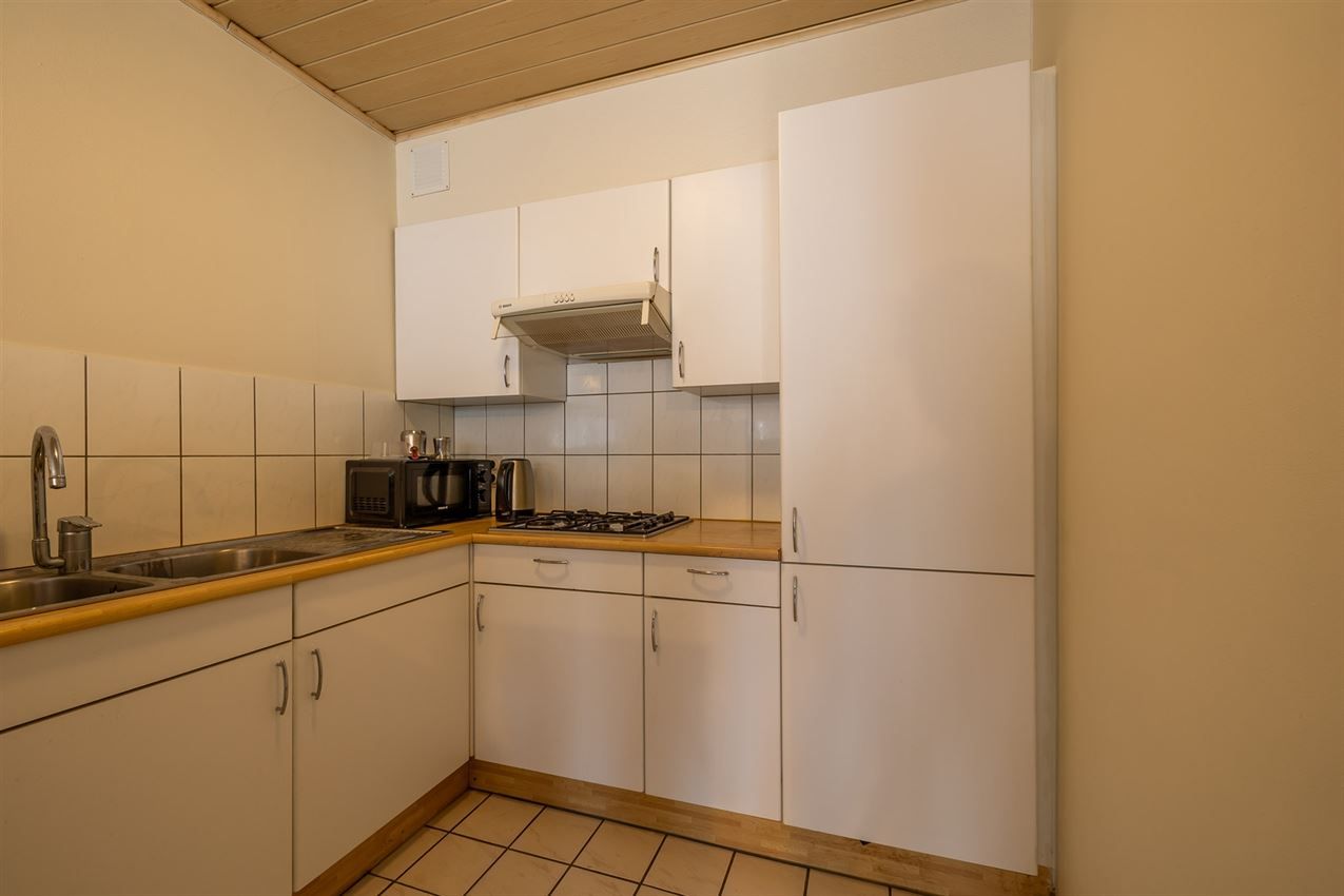 Verzorgd gebouw met handelszaak en 2 apt foto 24