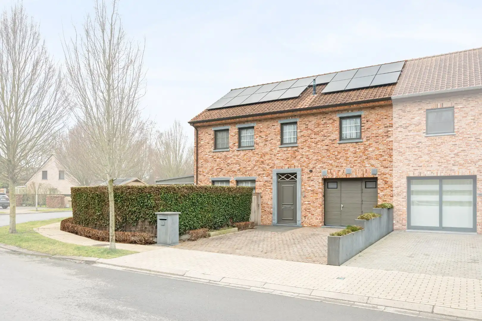 Recente halfopen woning met 3 slaapkamers, lift, garage en tuin op topligging in Ieper foto {{pictureIndex}}