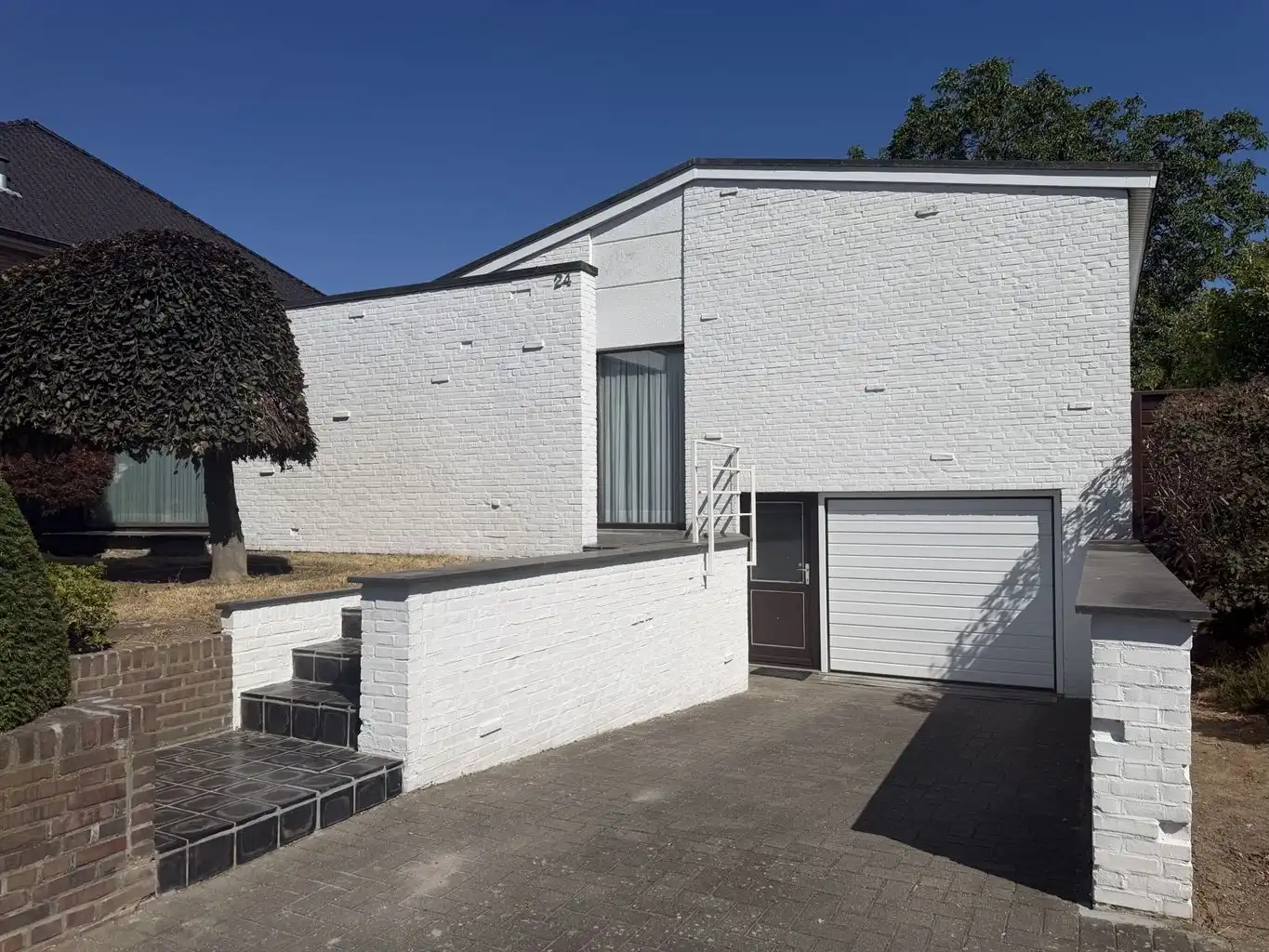 Vrijstaande splitlevelwoning met 3 (+1)slaapkamers, inpandige garage en carport, overdekt terras en omheinde tuin, gunstig gelegen nabij het centrum van Maaseik. foto 2