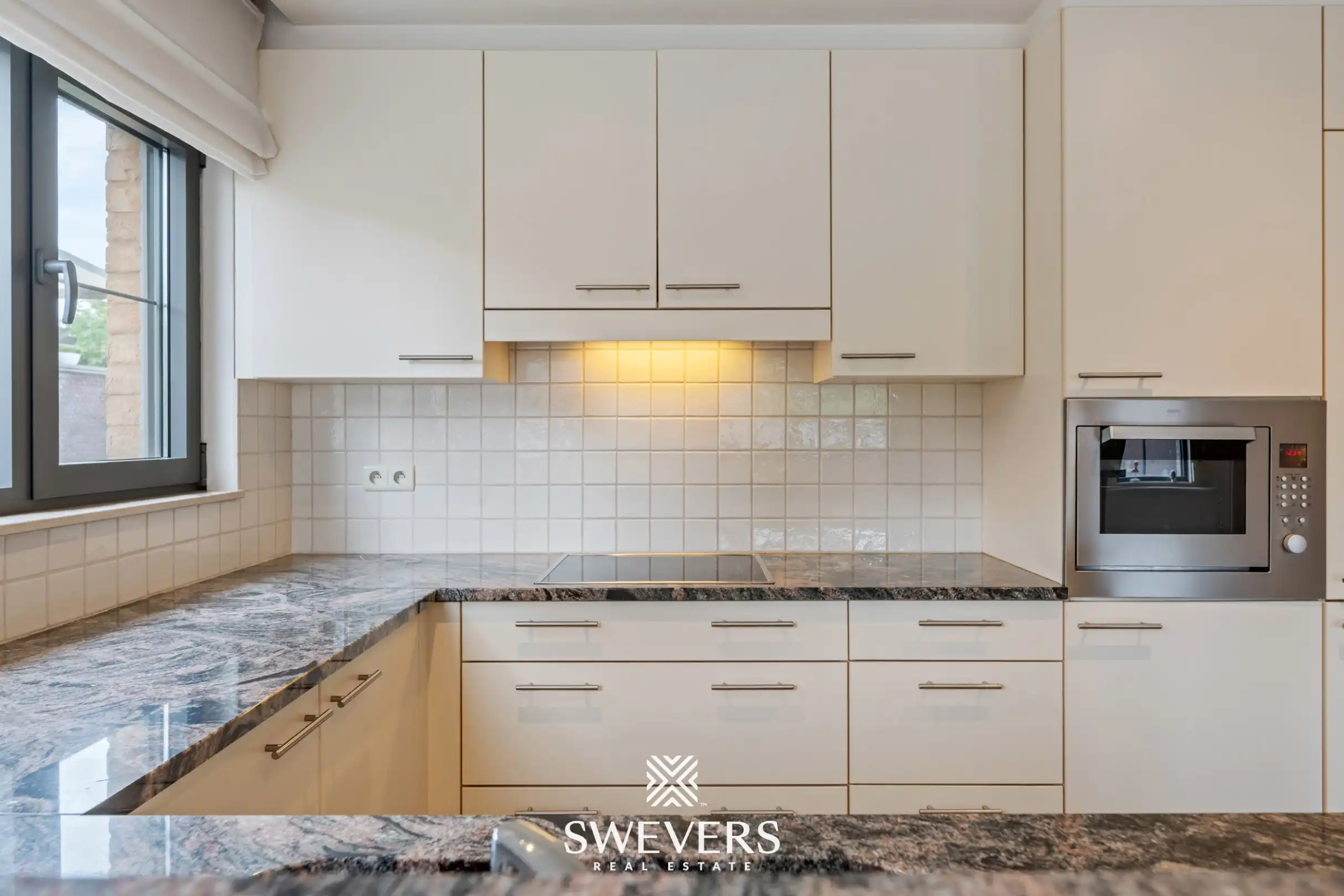 Ruim gelijkvloers appartement met tuin en ondergrondse autostaanplaats foto 8