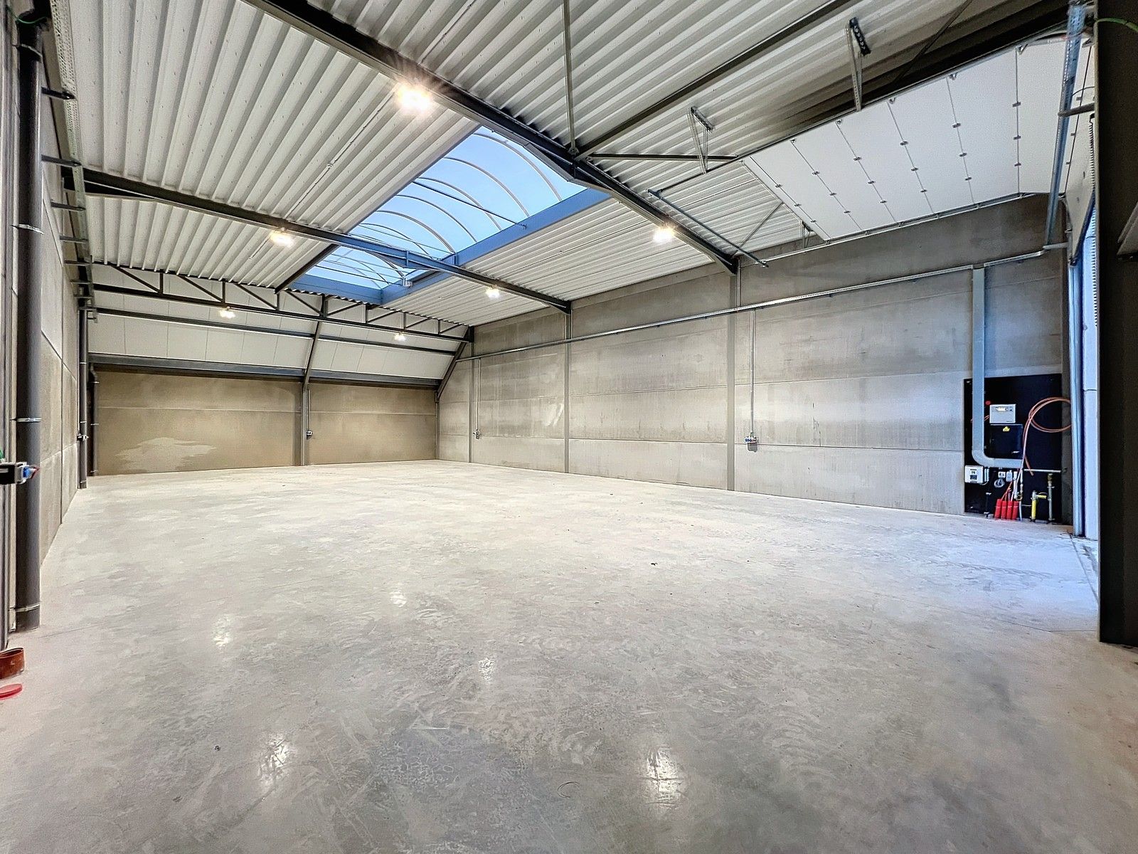 Kwalitatief en goed geïsoleerd NB MAGAZIJN (277m2), voorzien van elektrische sectionaalpoort, deur, raam (voor kantoor) en 2 private parkeerplaatsen op industriezone te Waregem. foto 2