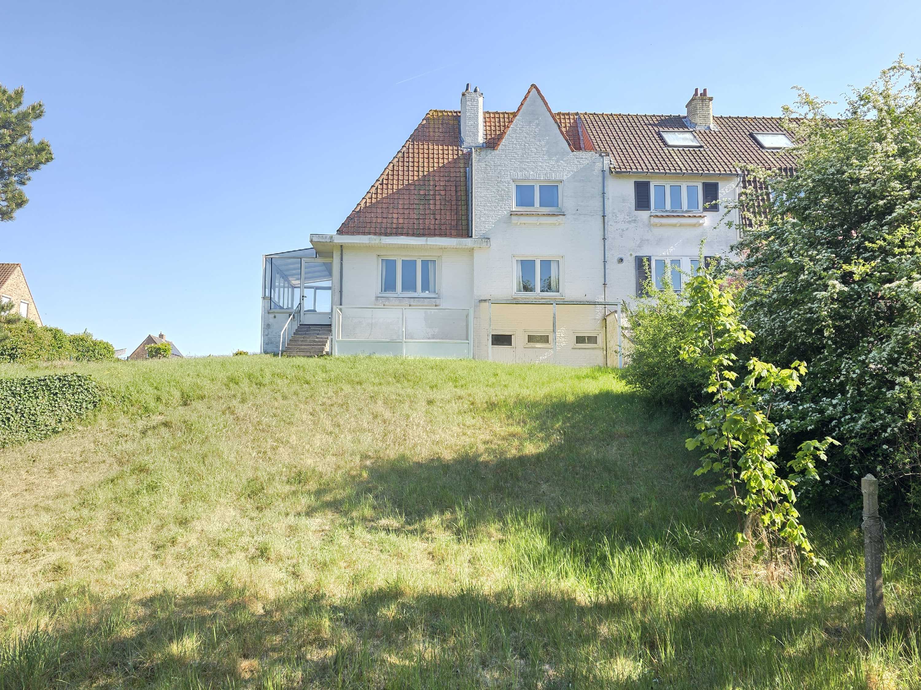 Op te knappen Halfopen bebouwing nabij de duinen te Oostduinkerke foto {{pictureIndex}}