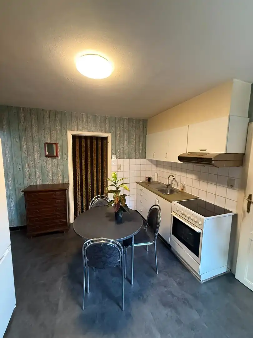 Opbrengsteigendom bestaande uit 2 halfopen woningen met garage en tuin te Hechtel. foto 5