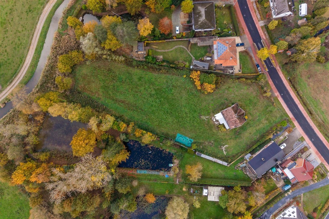 Uniek perceel van 50a33ca met af te breken woning aan agrarisch gebied foto 5