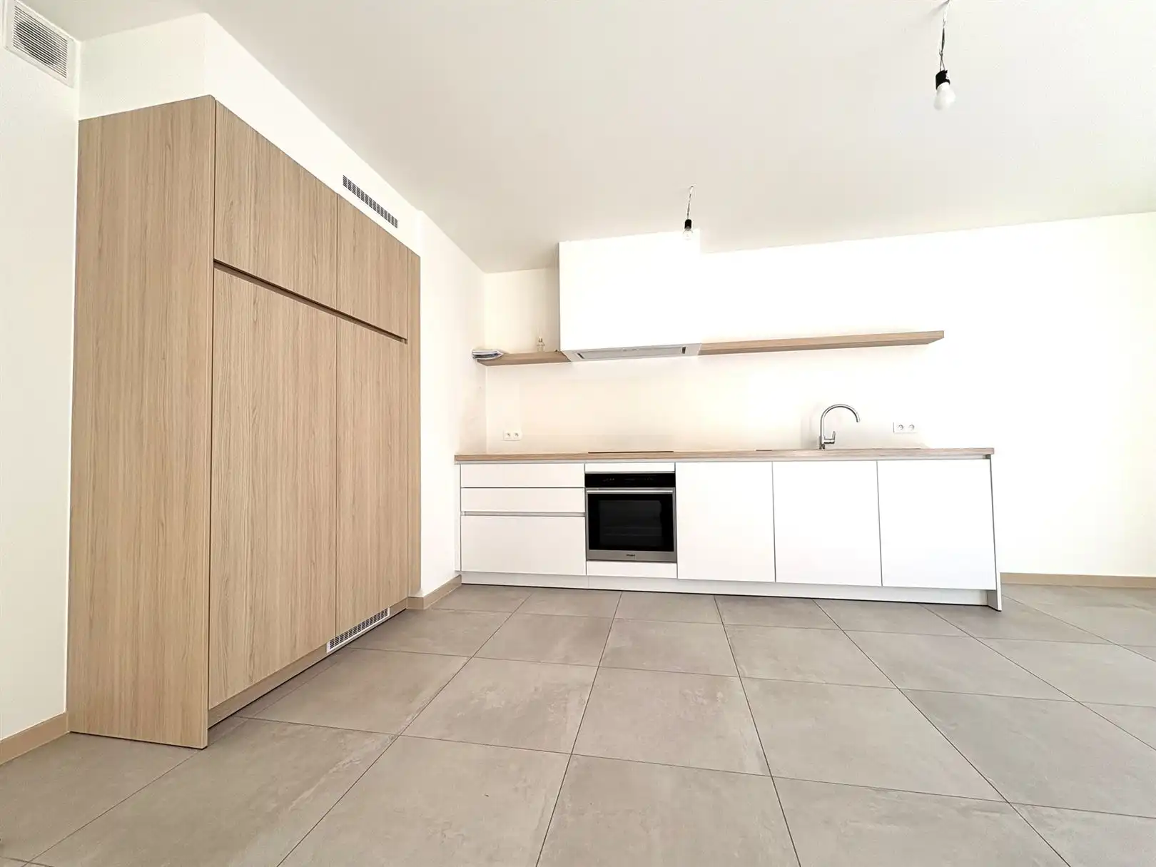 Modern en instapklaar gelijkvloers appartement met terras, tuin en ondergrondse staanplaats in Grembergen foto 5