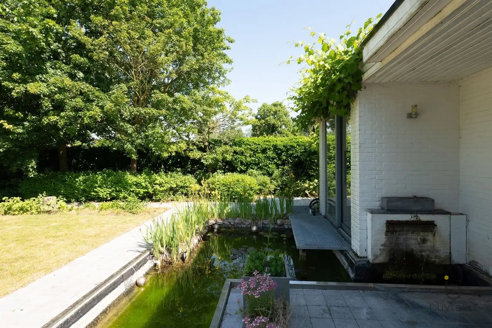 Te renoveren zonovergoten gelijkvloers 70’s woning met prachtige tuin en tal van mogelijkheden! foto 41