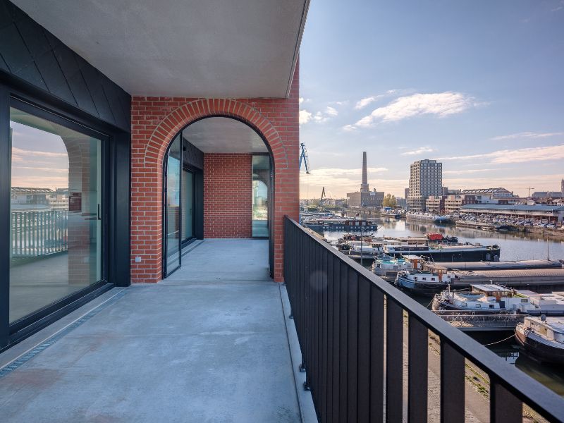 Ruim 2slpk-appartement met zuid-west georiënteerd terras aan de ‘Nieuwe Dokken’. Een appartement met een fenomenaal zicht over het water en de Gentse skyline! foto 4